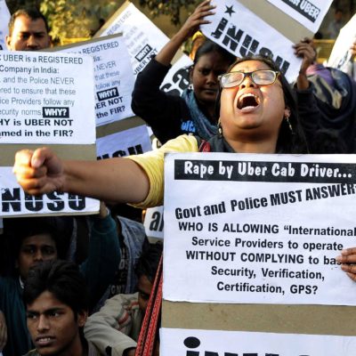 NEW DELHI, INDIA - DECEMBER 7: Jawaharlal Nehru University Students' Union (JNUSU) shout slogan against Delhi Police, hold protest against the shocking rape by UBER Cab Driver at PHQ ITO, on December 7, 2014 in New Delhi, India. A 27-year-old woman was allegedly raped by the driver of the cab she had hired through Uber to return home from a dinner party in Gurgaon on Friday night. The incident took place at around 9:30 pm when the woman, who works for a finance company in Gurgaon, was headed back to her home in north Delhi's Inderlok area. A rape case has been registered against the accused Shiv Kumar Yadav, 32 at Sarai Rohilla police station under Sections 376 (rape), 323 (voluntarily causing hurt) and 506 (criminal intimidation) of IPC. (Photo by Sonu Mehta/Hindustan Times via Getty Images)